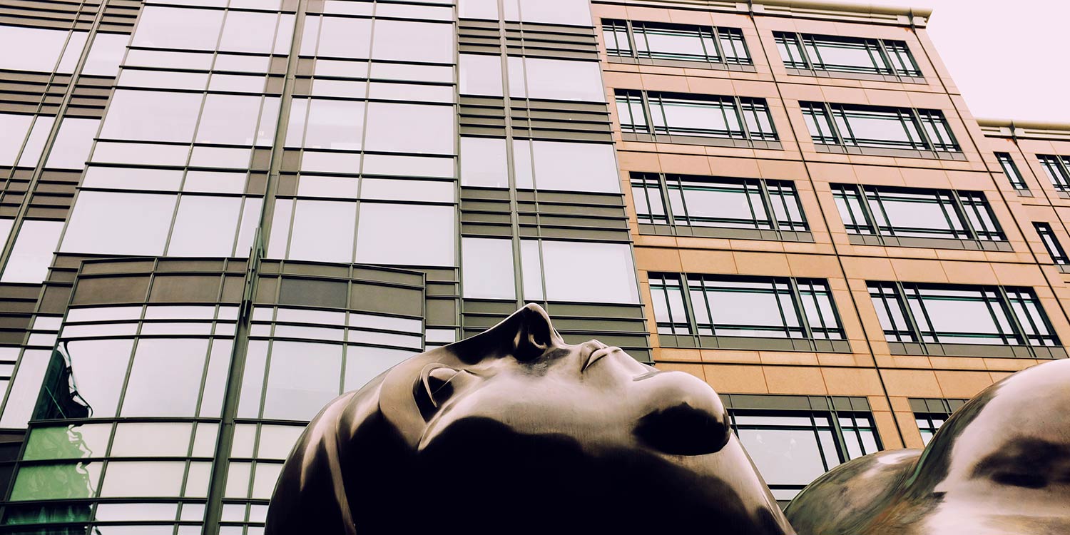 An sculpture of Botero's venus in front of an office building in London.