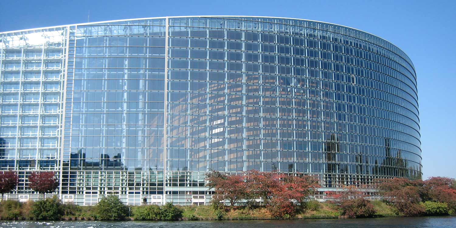 The EU Parliament building Strasbourg, a modern office building at a water front.