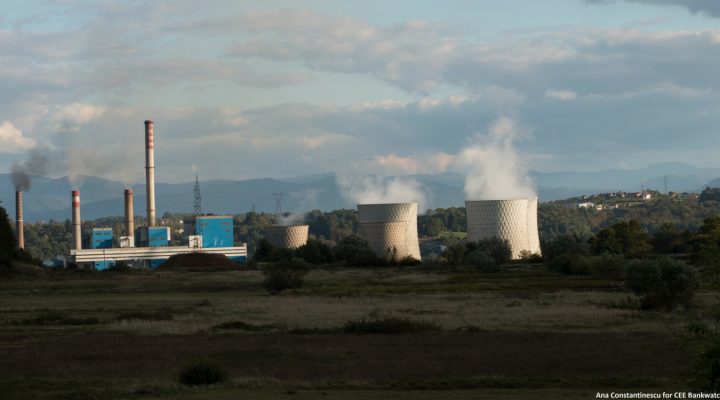 In a panorama view smoke and steam is coming out of the towers of a coal power plant.