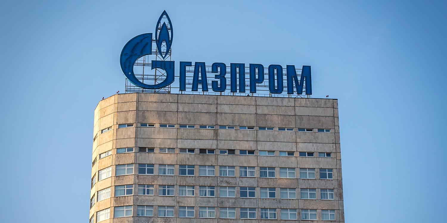 An old office building with a Gazprom sign on top.